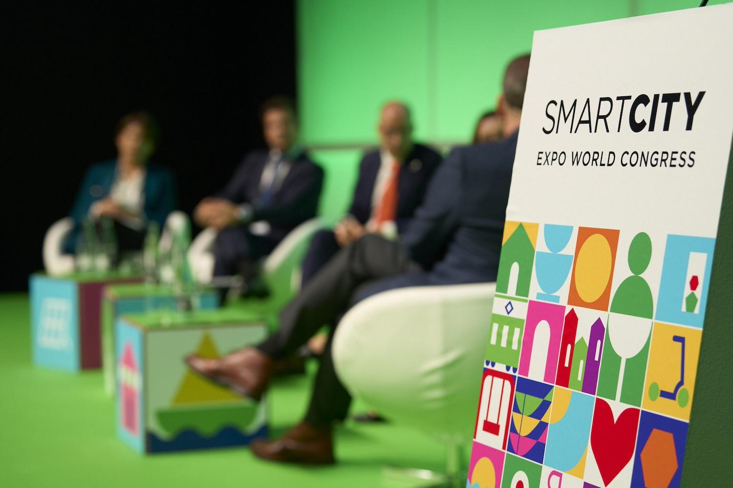 A "Smart City Expo World Congress" sign on stage at one of the event sessions.