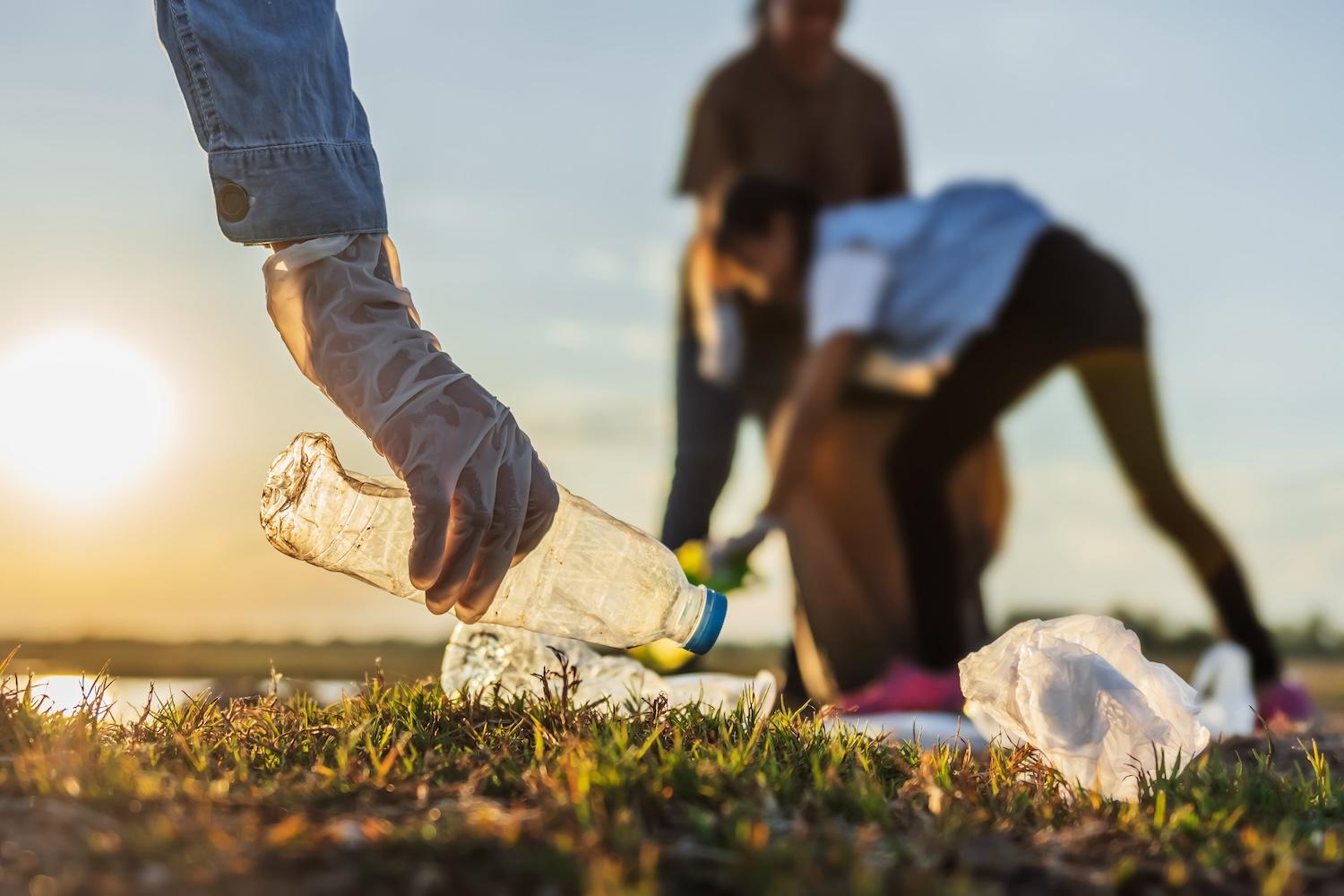 volunteers picking up plastic litter from park