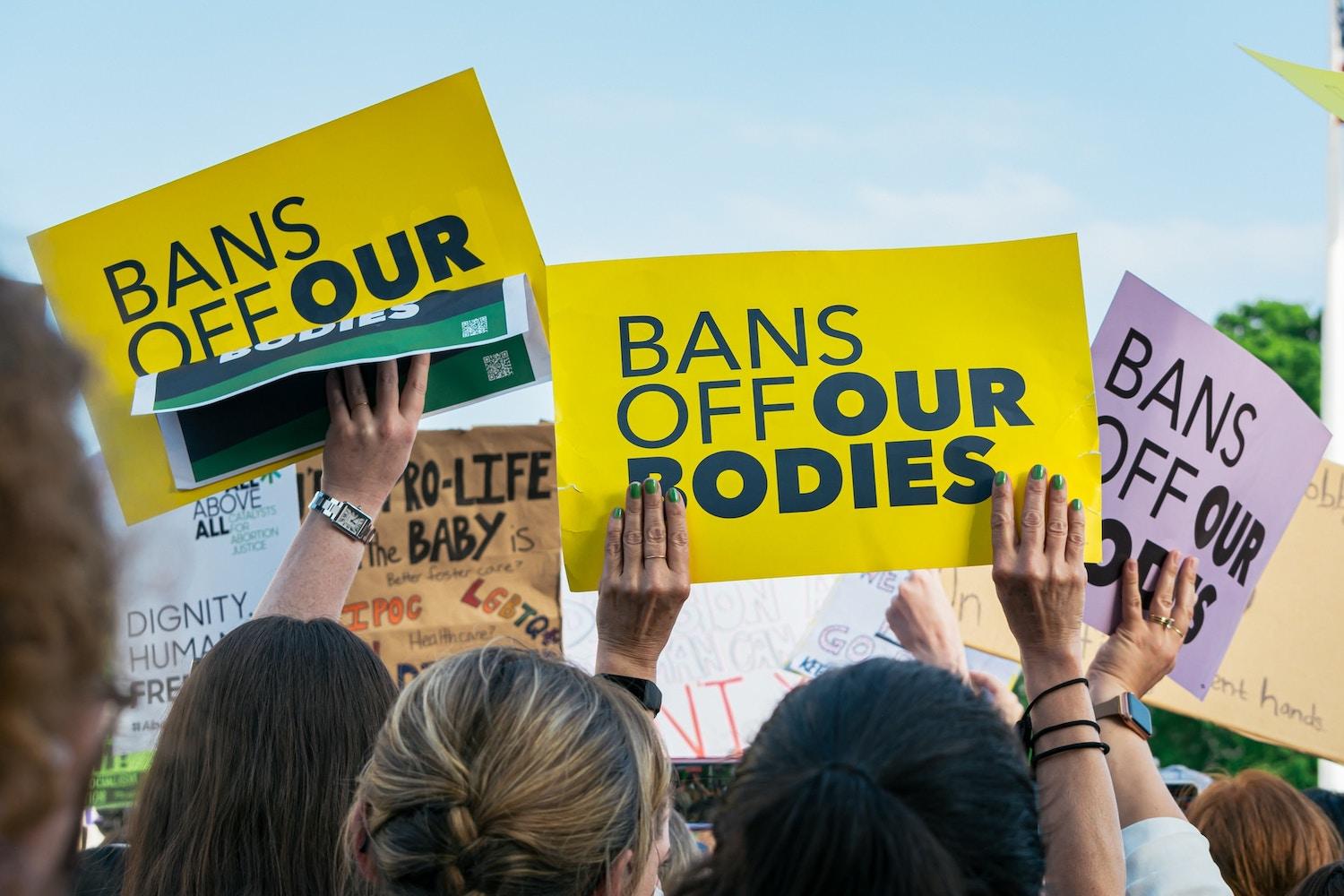 women hold signs in abortion rights protest - mifepristone ban roe v. wade overturned