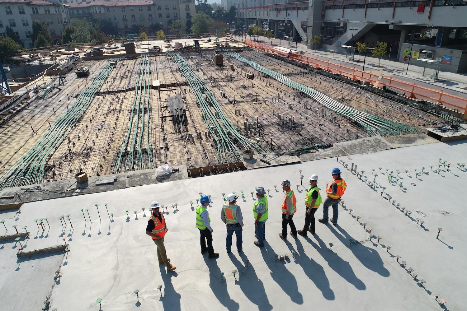 workers on a construction site — green building 