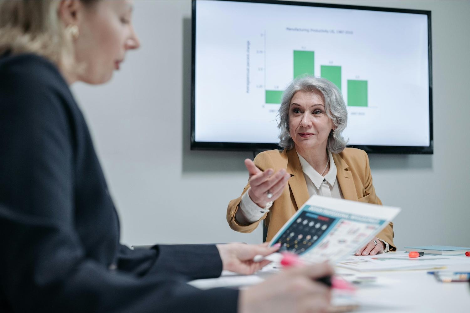 A woman sitting in a meeting — workplace ageism 