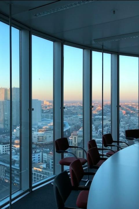 board room with glass windows and city skyline in the background