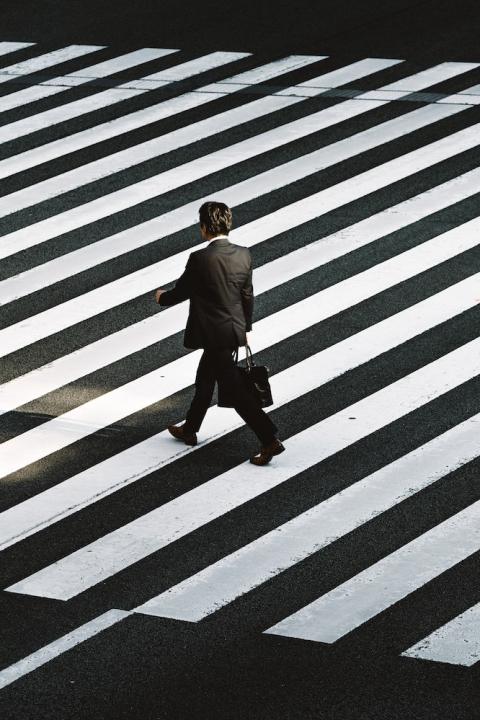 man in suit crossing street - CEOs - CEO