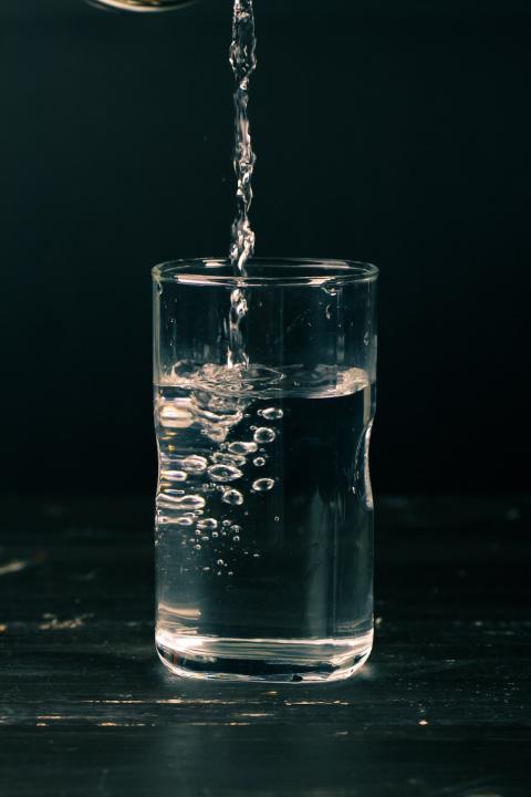 Water is poured into a glass. 