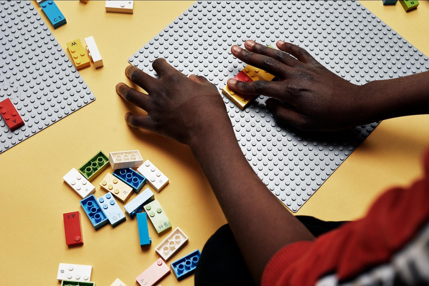 A child using Lego Braille Bricks. 