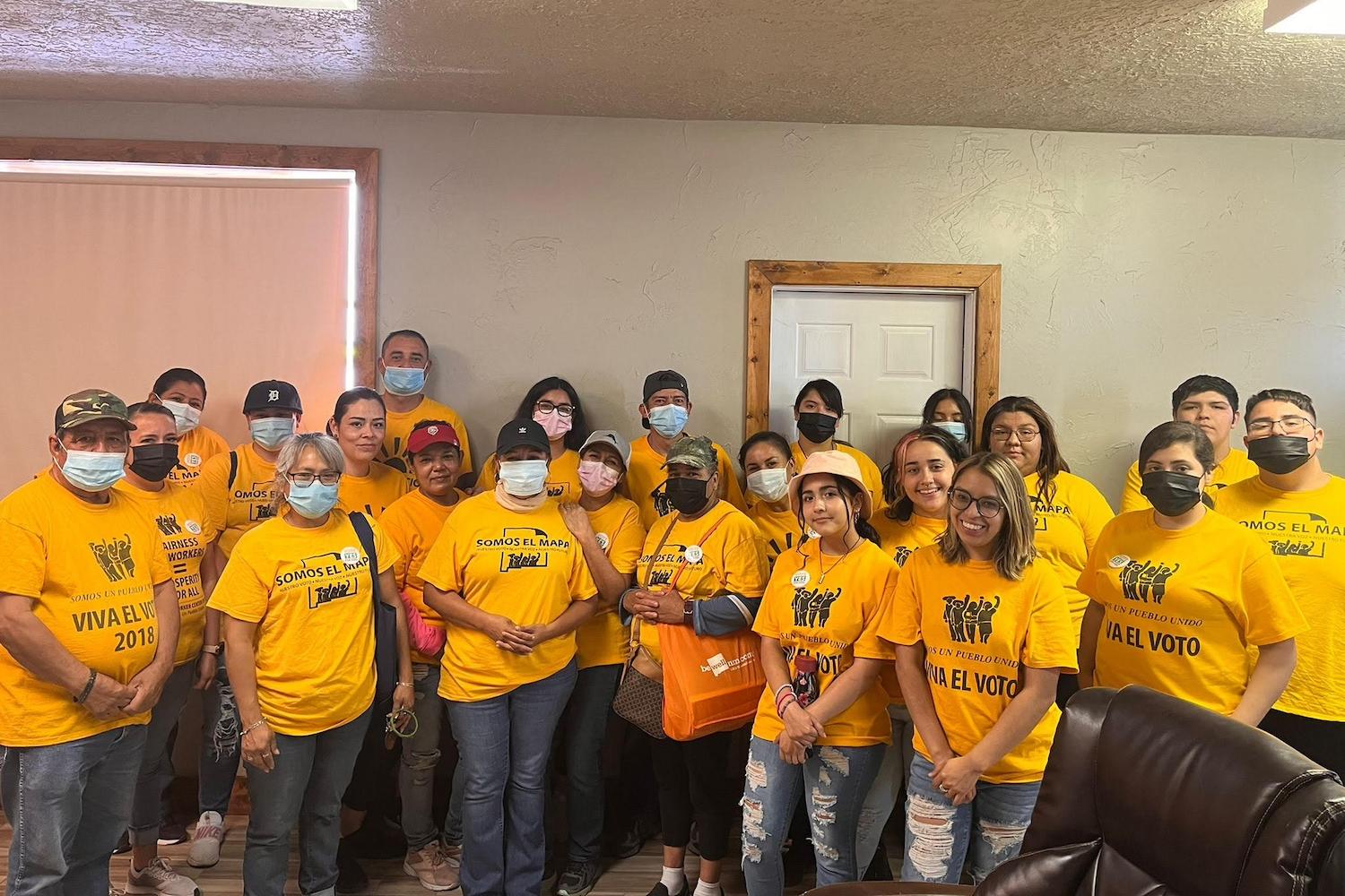 Members of Somos un Pueblo Unido smile for a group photo. 