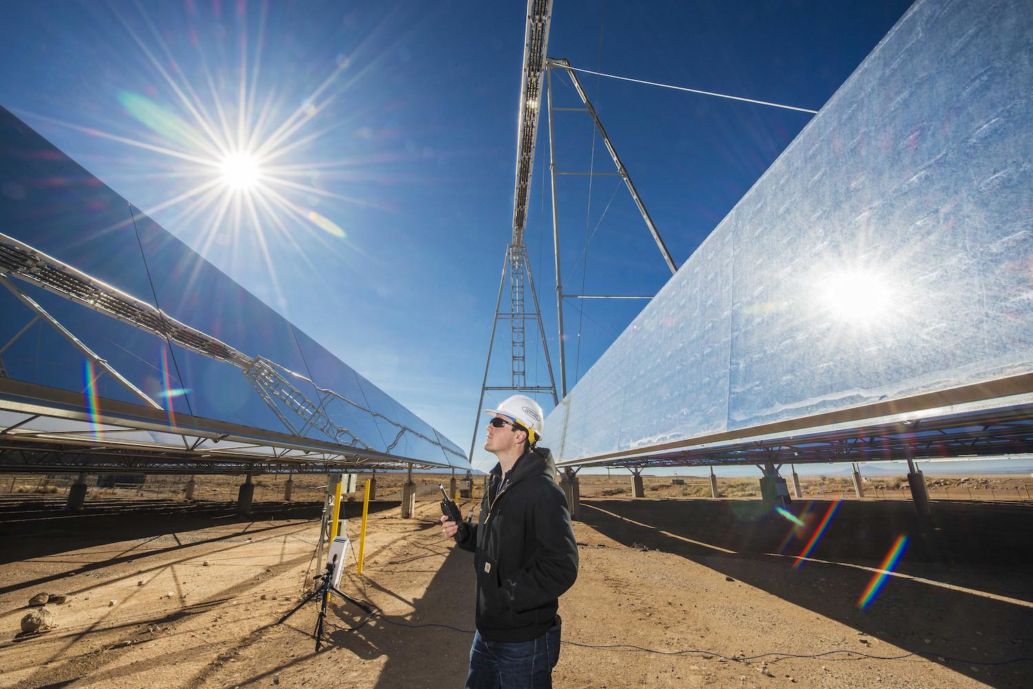 concentrating solar power - man stands at solar-thermal testing site in new mexico usa - clean power